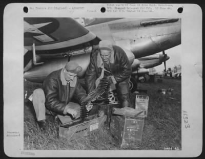 Thumbnail for General > Two armorers prepare the sting of an Eighth Fighter Command North American P-51 Mustang fighter before the airplane takes off on another of the around-the-clock missions that have been the order of the day since the invasion. The 50 caliber bullets