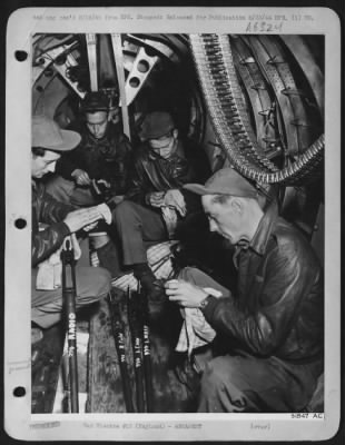 Thumbnail for General > Filling in the time lag between briefing and actual take-off, four gunners of the Boeing B-17 Flying ofrtress crew busy themselves cleaning and assembling their heavy 50 cal. Machine guns, a vital phase of the preparations. Left to right: T/Sgt.