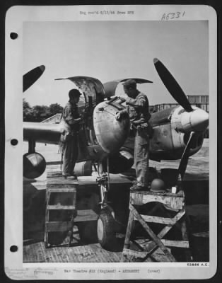 Thumbnail for General > Sgt. Sidney Simpkins, armorer, St. Louis, Mo., shown jamming cleaning rod into barrel of .50 caliber Lockheed P-38 Lightning gun while crew chief T/Sgt. Alvin L. Archer, Houston, Texas, inspects engine of P-38 which has only minutes ago returned