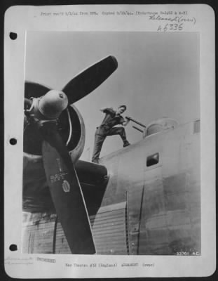 Thumbnail for General > ENGLAND-Pfc. Lloyd D. Taylor, Granby, Mo., armament man cleans the twin .50 caliber machine guns on the top turret of a Consolidated B-24 Liberator.