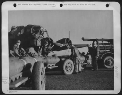 Thumbnail for General > Fins Go on! Trailers loaded with 500 lb bombs line up in front of ofrtress. Within a short time they will be tucked inside the bombay.