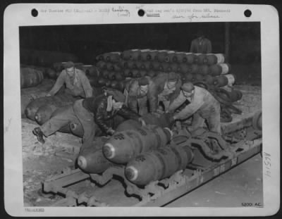 Thumbnail for General > Early in the evening preceding the opening assault, armoring crews begin their work of loading great armadas of American heavy bombers. Bombs must be hauled out of their racks in bomb dumps and bomb dispersal areas, placed on racks and pulled