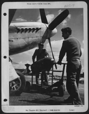 Thumbnail for General > Cpl. Leroy Turner, of Altoona, Pa., (left and Sgt. Henry A. Bucko, of Hammond, Ind., caught wheeling out a bomb trailer with a 500 pounder under the nose of a P-51 Mustang "Yahootie Too" for loading on the plane flown by 1st Lt. John R. Bernert