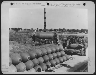 Thumbnail for General > ENGLAND-Stacked up two thousand pound bombs loaded on a trailer for delivery to a bomb bay of a Consolidated B-24 which will forward them to Germany (K2385).