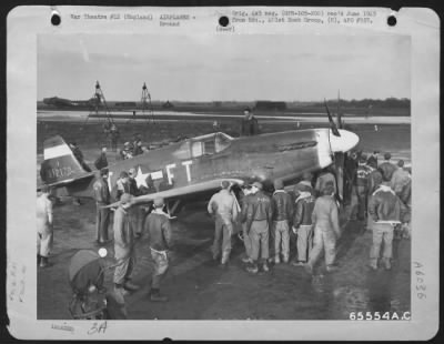 North American > Men Of The 401St Bomb Group Look Over A North American P-51B "Mustang" At An 8Th Air Force Base In England, 27 December 1943.