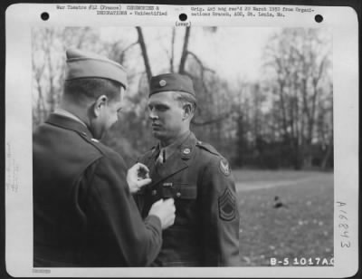 Unidentified > Brig. General John P. Doyle presents an award to a member of the 320th Bomb Group during a ceremony at an airbase at Dijon, France. 1945.