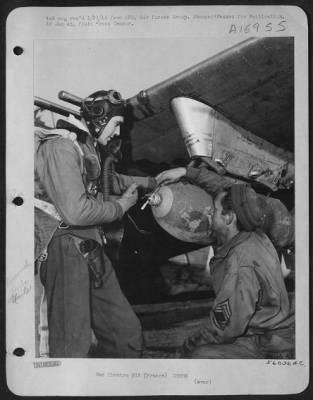 General > Major Gilbert F. Talbot, left, Clackamas, Oregon, a pilot in the 354th fighter-bomber group, and M/Sgt. Joseph Scruggs, Odessa, Texas, an armorer, examine the 500 pound bomb slung under a wing of the Major's Republic P-47 Thunderbolt at a 9th