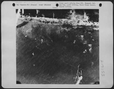 Thumbnail for General > Avoiding the great craters left by bombs of the 8th AAF, landing craft nose into the shore somewhere along the beach-head on the coast of Nazi held France.Army vehicles dotting the shore shown in this Eighth Air force Reconnaissance photo.