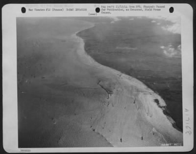 Thumbnail for General > During the early days of the invasion, ships were deliberately sunk to create breakwaters for the protection of shipping facilities at the beachheads. A string of ten ships, scuttled to ofrm an "L," is shown here off an American beachhead in Normandy