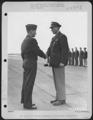 Unidentified > Major General Samuel E. Anderson Congratulates An Officer Of The 386Th Bomb Group After Presenting Him The Distinguished Flying Cross During A Ceremony At An Air Base Somewhere In Beaumont, France.  15 March 1945.