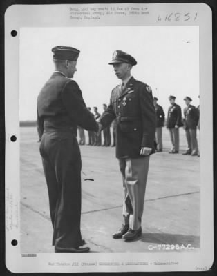 Unidentified > Major General Samuel E. Anderson Congratulates An Officer Of The 386Th Bomb Group After Presenting Him The Distinguished Flying Cross During A Ceremony At An Air Base Somewhere In Beaumont, France.  15 March 1945.