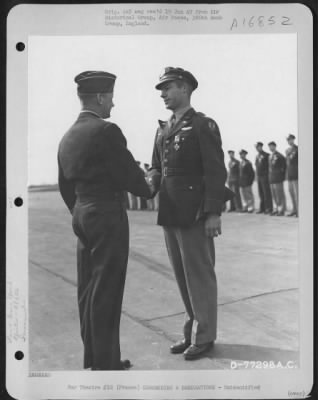 Unidentified > Major General Samuel E. Anderson Congratulates An Officer Of The 386Th Bomb Group After Presenting Him The Distinguished Flying Cross During A Ceremony At An Air Base Somewhere In Beaumont, France.  15 March 1945.