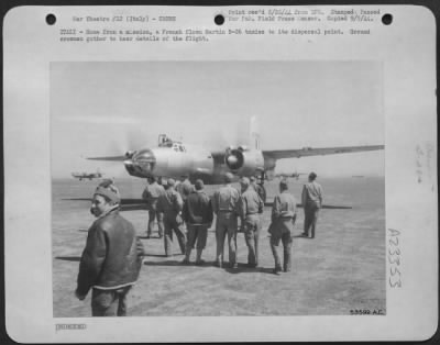 Thumbnail for Consolidated > ITALY-Home from a mission, a French flown Martin B-26 taxies to its dispersal point. Ground crewmen gather to hear details of the flight.