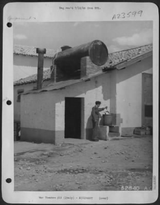 Consolidated > ITALY-Photo shows improvised sanitary devices in a building adjoining mess hall. A 55 Gallon drum is shown mounted on roof of this building. Shown in use is a compact hot water device for dipping mess kits before serving.