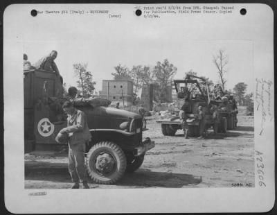 Thumbnail for Consolidated > AAF Engineers unload heavy equipment at an Italian airdrome recently captured from the enemy, to begin a rush job of rehabilitating the field for use by Allied fighters, bombers and transports.