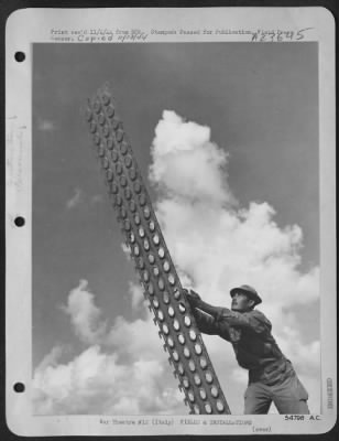 Thumbnail for Consolidated > ITALY-After the air strip has a smooth face, the Air Corps novel metal stripping sees to it that it stays smooth during the winter months. Pvt. Gregario B. Lopez, 34, Bastrop, Texas of an Aviation Engineer group of the Mediterranean Allied Air Forces