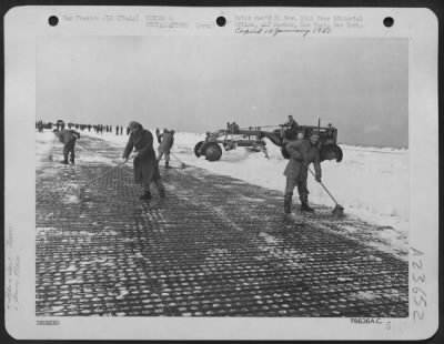 Thumbnail for Consolidated > Every available tool was used to clear the runway of an airfield below sea level maintained by an engineers aviation battalion in Italy following its first experience with a snow storm. The engineers are working here with large straw brooms and a