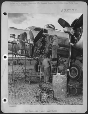 Thumbnail for Consolidated > ITALY-Bombers require loving care and speedy attention from ground maintenance men to keep 'em flying. Here an engine crew works wurely and swiftly to repair flak damage.