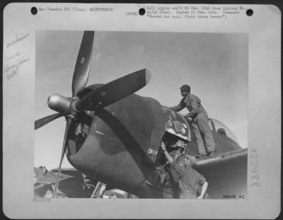 Consolidated > Two Brazilian plane mechanics servicing the Republic P-47's that the Brazilian pilots fly in the First Brazilian Fighter Squadron. ITALY.