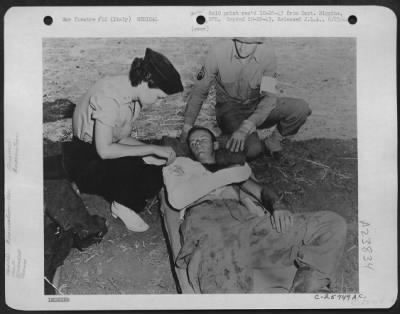 Thumbnail for Consolidated > Nurse Verona Savinski, 802nd Medical Air Evacuation Transport Squadron and Cpl. Claude W. Thomas, 3rd Auxiliary Surgical Group, with PFC Joe Hirsch of Brooklyn, N.Y., 504th Paratroops Infantry, who was strafed while rushing to the front after jumping