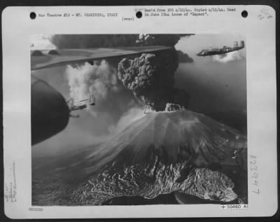 Thumbnail for Consolidated > Winging their way toward the front to bomb German troops in the Cassino area, North American B-25s of the 12th Air Force pass Mt. Vesuvius as she coughs up ash and smoke thousands of feet into the air. Crew members reported the air very turbulent in