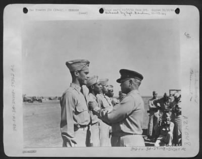 Consolidated > ITALY-Gen. Benjamin O. Davis pins the Distinguished Flying Cross on his son, Col. Benjamin O. Davis, Jr., 1721 S Street NW, Washington, D.C. Capt. Joseph D. Elsberry, 1114 W. Washington Blvd., Langston, Okla; 1st Lt. Jack D. Holsclaw, 2301 W.