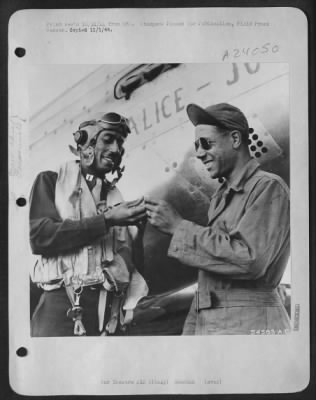 Thumbnail for Consolidated > ITALY-Captain Wendell O. Pruitt, 23m, of St. Louis, Mo., one of the leading pilots in the 15th Air Force makes sure that he leaves his valuable ring with his smiling crew chief, S/Sgt Samuel W. Jacobs, 24, of Los Angeles, California.