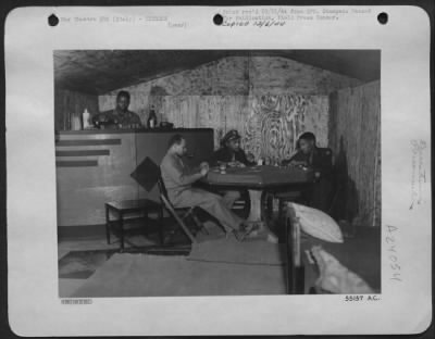 Thumbnail for Consolidated > ITALY-This cozy home, built in six days by Sgt. Fred Robinson of Yorktown, Virginia, boasts hot and cold running water, sink, poker table and service bar. Left to right: Sgt. Fred Robinson; Maj. Elmer D. Jones, Jr., Washington, D.C.; 1st Lt. John