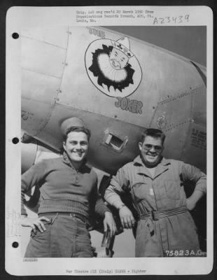 Thumbnail for Consolidated > Two Ground Crew Members Of The 94Th Fighter Squadron, 1St Fighter Group, Pose Beside Their Lockheed P-38 Lightning At An Airfield Somewhere In Italy.  ['The Joker']