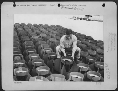 Consolidated > 'This Is No Joke, I'Ve Plenty Of Fins, But Still I'M Broke,'  Says Sgt. Cormac P. Drury, 28 Spring St., Wilkes-Barre, Penn., An Ordnance Non-Com With Consolidated B-24 Liberator Bomb Group In The 15Th Af, Italy.  These Fins Are Attached To Bombs Before Th