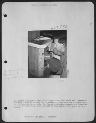 Thumbnail for Consolidated > Sgt. Joseph L. Byrnes, Husband Of Mrs. J.L. Byrnes, 709 1/2 Garvin Ave., Charleston, Va, Reaches In Cupboard For His Toilet Kit, Underneath The Porcelain Basin That He Installed In His Tent.  Sgt. Byrnes, An Airplane Mechanic In A Consolidated B-24 Libera