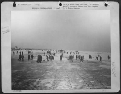 Thumbnail for Consolidated > Magnitude Of Work Confronted By American Aviation Engineers After A Voilent Snowstorm Over This Below-Sea-Level Airfield In Italy Can Be Seen By This Runway Being Cleared.  Two Hours Earlier The Field Was Buried In Snow.  But Engineers Made It Possible Fo