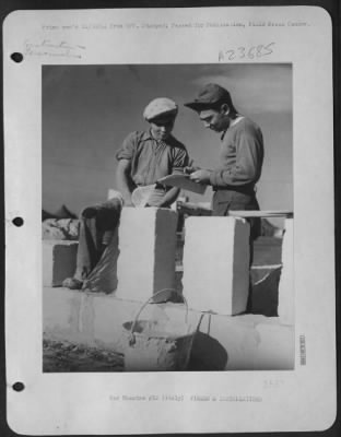 Thumbnail for Consolidated > Left, An Italian Laborer, And Right, Sgt. David J. Pulizzi, From Chicago, Ill., A Welder At A 15Th Af Base, Go Over The Plans For A Stone Villa.  The Gi'S At This Base Holed Up For The Winter In Comfortable Little Villas That They Built Themselves.  The B