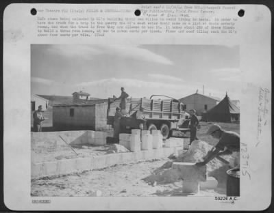 Thumbnail for Consolidated > Tufa Stone Being Unloaded By Gis Building Their Own Villas To Avoid Living In Tents.  In Order To Have The Truck For A Trip To The Quarry The Gi'S Must Enter Their Name On A List At Their Oderly Rooms, And When The Truck Is Free They Are Allowed To Use It