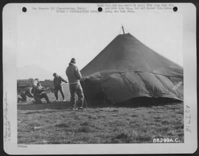 Thumbnail for Consolidated > These Men Of The 79Th Fighter Group In Capodichino, Italy, Put Their Tent Up While A Strong Wind Is Blowing.  Mt. Vesuvius Can Be Seen In The Background.