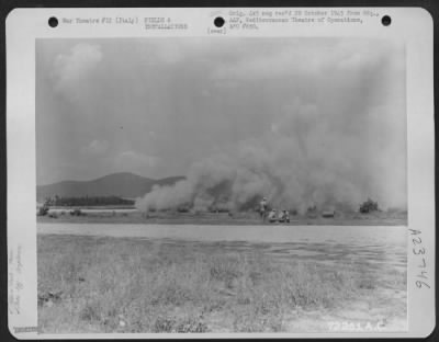 Thumbnail for Consolidated > Dust, A Major Problem For Aviation Engineers On Airfields Of The 12Th And 15Th Air Forces, Sweeps Across This Field In Italy As An Airplane Rolls Down The Runway Before Taking Off.