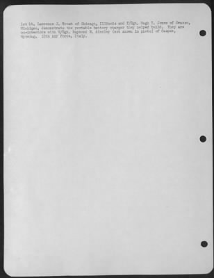 Thumbnail for Consolidated > 1St Lt. Lawrence J. Trost Of Chicago, Ill., And T/Sgt. Hugh T. Jones Of Owasso, Michigan, Demonstrate With The Portable Battery Charger They Helped Build.  They Are Also Co-Inventors With M/Sgt. Raymond W. Ainsley (Not Shown In Photo) Of Casper, Wyoming.