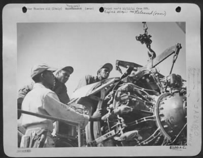 Thumbnail for Consolidated > Busy At The Ticklish Job Of Removing An Aircraft Engine From The Engine Seat In The Wing, Are Three Aircraft Mechanics Of The All-Negro Service Group.  L. To R. Are, Sgt. Bonnie D'Garden, Of 270 Hudson, St., Jackson, Misissippi; Sgt. Thomas L. Greggs, 191