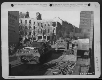 Thumbnail for Consolidated > The first tanks and tank destroyers enter Aachen, Germany, where fighting still continues, shortly after Artillery batteries and 9th AF dive-bombers had bombarded enemy positions. Destruction visible in the picture resulted from the combined power of