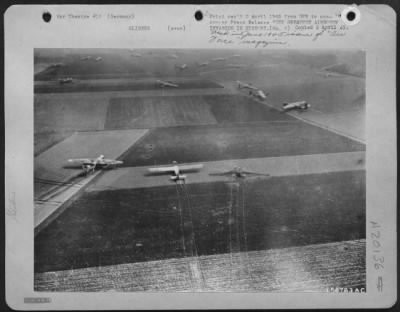 Consolidated > THE GREATEST AIRBORNE INVASION IN HISTORY---Trails left by landing gliders can be seen in the German fields pictured with many of the aircraft in various landing positions. One glider of this group burned. The troops later received supplies dropped