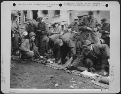 Thumbnail for Consolidated > German soldiers who surrendered with the defending garrison at Aachen, Germany, are given a thorough "shake-down" by Yank MP's before being shipped to prison camps.