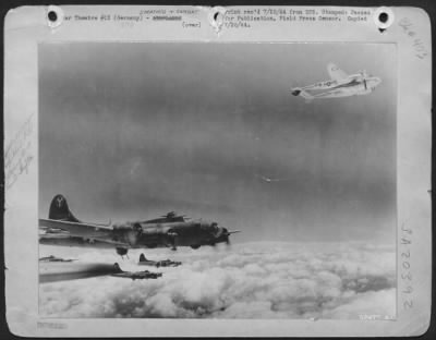 Thumbnail for Consolidated > One of the Lockheed P-38 Lightnings that escorted these Boeing B-17 Flying Fortresses of the 15th AAF over Bleckhammer, Germany, on 7 July 1944 was hit by flak. With its prop feathered, it returned to its base under the protection of the heavy