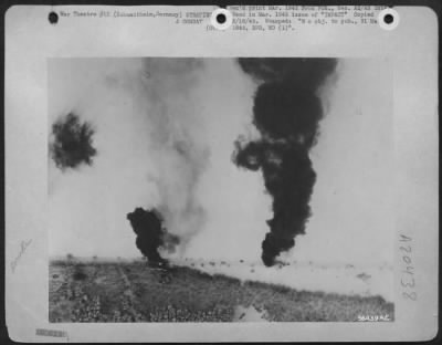 Thumbnail for Consolidated > Black columns of smoke stream from two Nazi trucks near Schuadtheim, Germany. Eight others damaged line the highway.