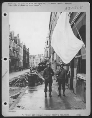 Thumbnail for Consolidated > "WHITE FLAG ALLEY" was the term used by U.S. troops to describe streets in Cologne after the entry by the First Army. Two military policemen, Sgt. Robert Hefferan, Ada, Mich., left and Pfc. Harold Moats, Springfield, Ohio, are shown examining a large