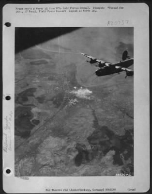 Thumbnail for Consolidated > One of the attacking Consolidated B-24 Liberators of the U.S. 8th AF leaves the rail yards at Aschaffenburg, Germany burning in the background as the heavies head for home after successful attacks on Nazi communications for the seventh consecutive