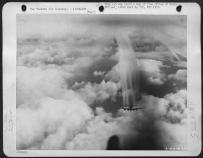 Thumbnail for Consolidated > With Dense Cloud Formations Below It A Boeing B-17 Flying Fortress, Part Of A Formation Of The 452Nd Bomb Group Leaves Contrails Of Condensing Vapor To Mingle With The Clouds As The Formation Drones Toward Its Objective Of Frankfurt, Germany, 20 March 194