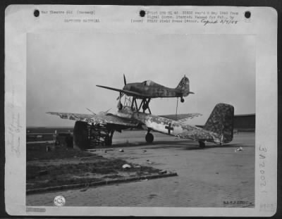 Thumbnail for Consolidated > Pick-A-Back Plane -- Pictured Is The German Pick-A-Back Plane Captured By The 1St Us Army In Merseburg Airport, Germany.  The Pilot Supposedly Controlled The Bomb Laden Ju 88 By Remote Control From A Fw-190 Attached Above.  When Over The Target, The Ju 88