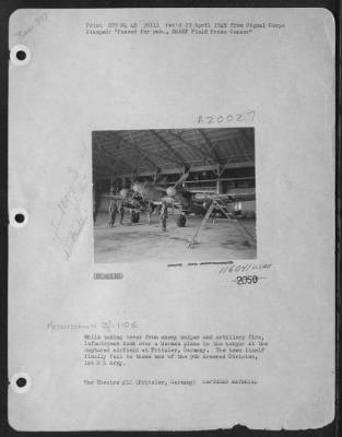 Consolidated > While Taking Cover From Enemy Sniper And Artillery Fire, Infantrymen Look Over A German Plane In The Hangar At The Captured Airfield At Fritzler, Germany.  The Town Itself Finally Fell To These Men Of The 9Th Armored Division, 1St U.S. Army.