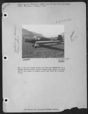 Thumbnail for Consolidated > One Of The Collecting Points For Arms And Ammunition At A German Airfield Where Several German Army Planes Are Held.  One Of The Planes Is Taxied Across The Field By A German Pilot.