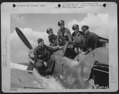 Consolidated > 1St Lt. Robert C. Thoman, Rochester, Ny, Who Recently Shot Down An Me-109, Examines The Cockpit Of A Similar Enemy Plane At A Former Luftwaffe Field As Fellow 9Th Af Republic P-47 Thunderbolt Pilots Look On.  The Pilots Were Given The Opportunity To See A